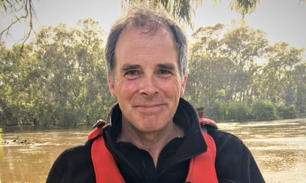 Biologist and environmental science teacher, Peter Phillips, sampling the blackwater in the 2016 flood, Swan Hill, Victoria.