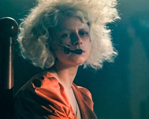 Jessie Buckley as The Bride, with black stain round her mouth.