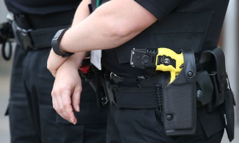 A police officer carrying a Taser