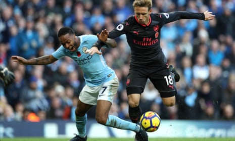 Manchester City’s Raheem Sterling, left, was accused by Arsène Wenger of diving to win a penalty from this challenge by Arsenal’s Nacho Monreal.