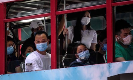 Commuters wear face masks as they travel on a tram in Hong Kong