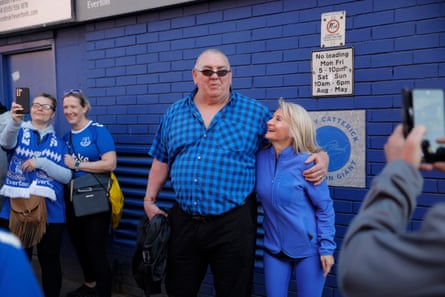 Fans take photos with the former Everton goalkeeper Neville Southall on Goodison Road