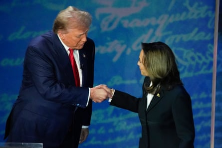 a woman and a man shake hands