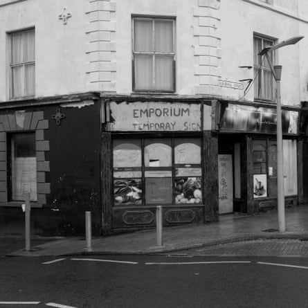 A shop with a sign reading "Emporium: Temporay Sign"