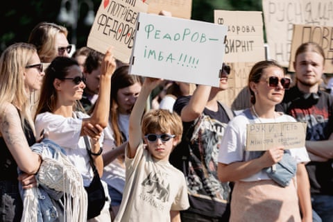 Protesters hold a rally with posters calling for peace