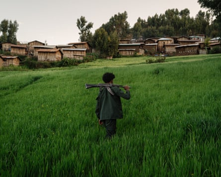 A young Fano soldier crosses a field with a weapon on his shoulder