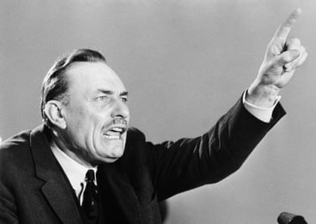 Enoch PowellA black and white photograph of Enoch Powell holding his arm up and pointing, and looking angry, while making a speech