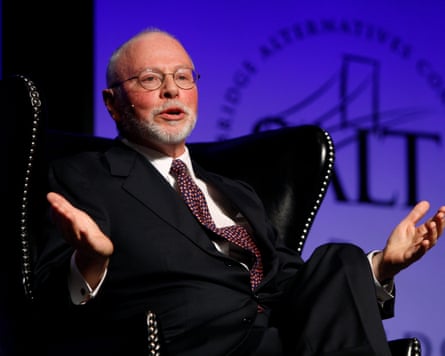 Paul Singer sitting in chair with arms open