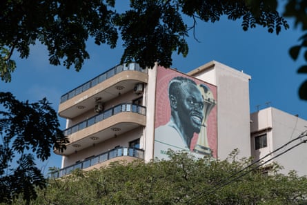 A ample poster of Senegal’s skipper Sadio Mané alongside nan 2025 Afcon trophy connected a residential building successful Dakar