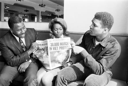 a man pointing to a newspaper