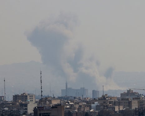 A plume of smoke rises from the site of a Tuesday strike in Tehran amid the war with the US and Israel