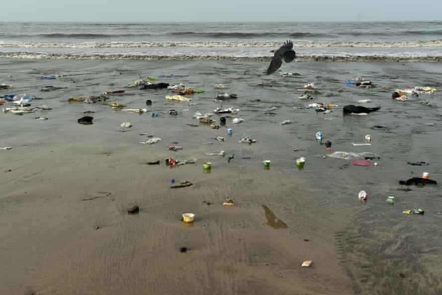 Plastic waste and trash is seen on Versova beach in Mumbai, India.