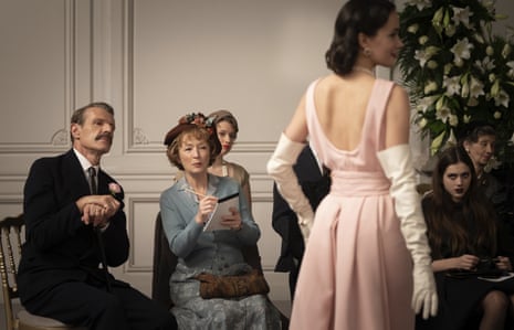 Lesley Manville looks at a model in a couture gown in Mrs Harris Goes to Paris.
