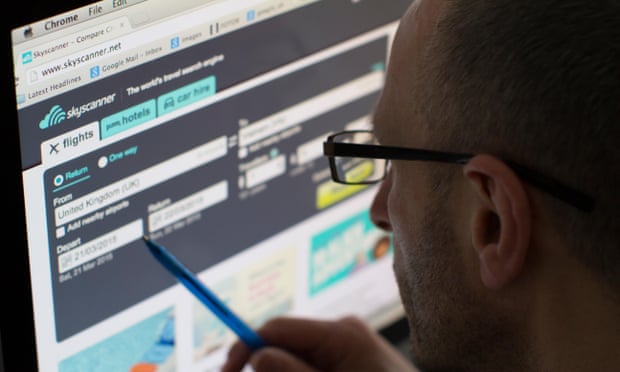 A man looks at the Skyscanner website