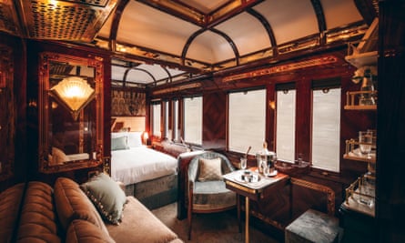 A beautiful art deco sleeping compartment with a high roof and highly polished panelling and marquetry, with a built-in double bed ands settee