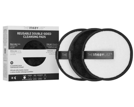 3 black and white reusable cleansing pads are to the right of their box packaging.