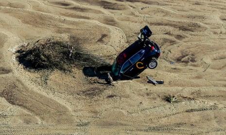 A car stuck in sand is seen in the aftermath of Cyclone Gabrielle in the Esk Valley near Napier