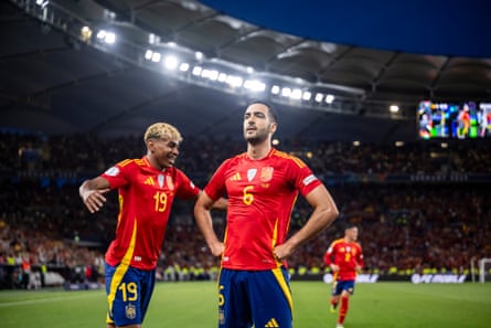 Mikel Merino celebrates with teammate Lamine Yamal