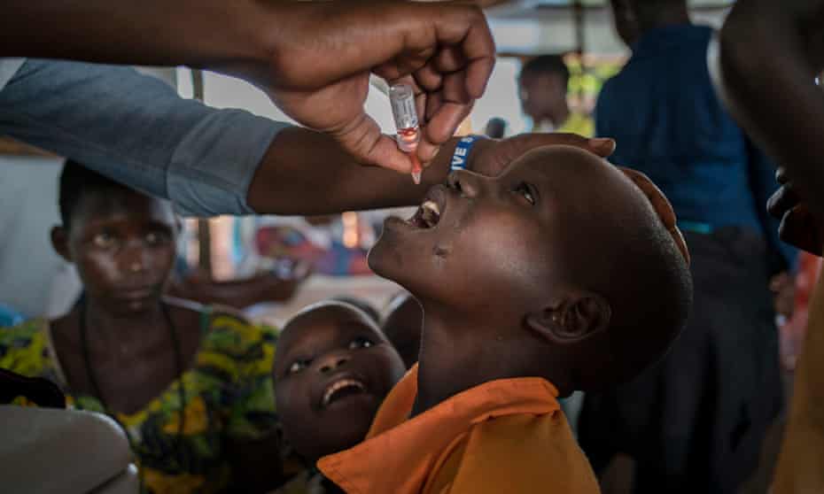 A Congolese refugee child receives a polio vaccine