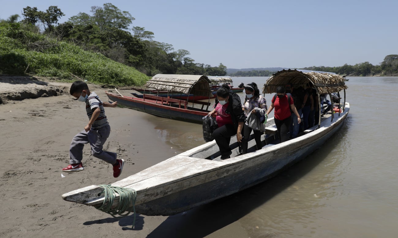 Migrants trying to reach the US disembark in Frontera Corozal, Mexico, after crossing the Usumacinta River from Guatemala
