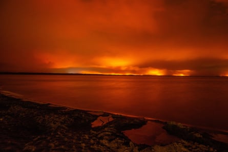 The wildfire turns the sky red over Lake Moutchic