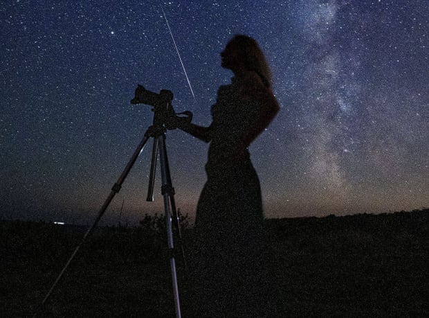 A photographer waits for a meteor shower
