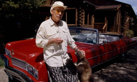 Fear and petting … Thompson with his pet wolverine and his cherry-red Pontiac at his Colorado cabin.