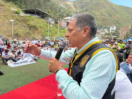 A man with a mic speaks to a crowd