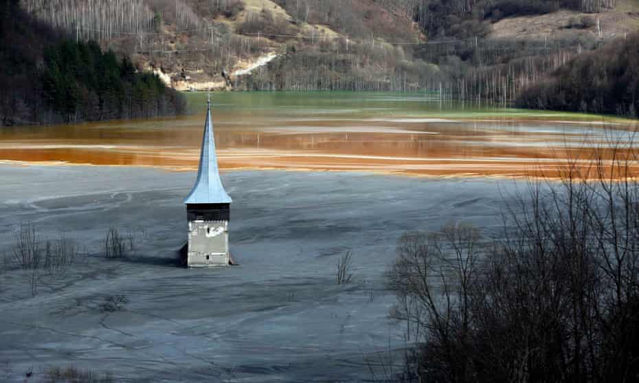 The church spire of Geamana village is submerged by toxic water tainted with cyanide and other chemicals from a copper mine begun in the 1970s near Roșia Montană.