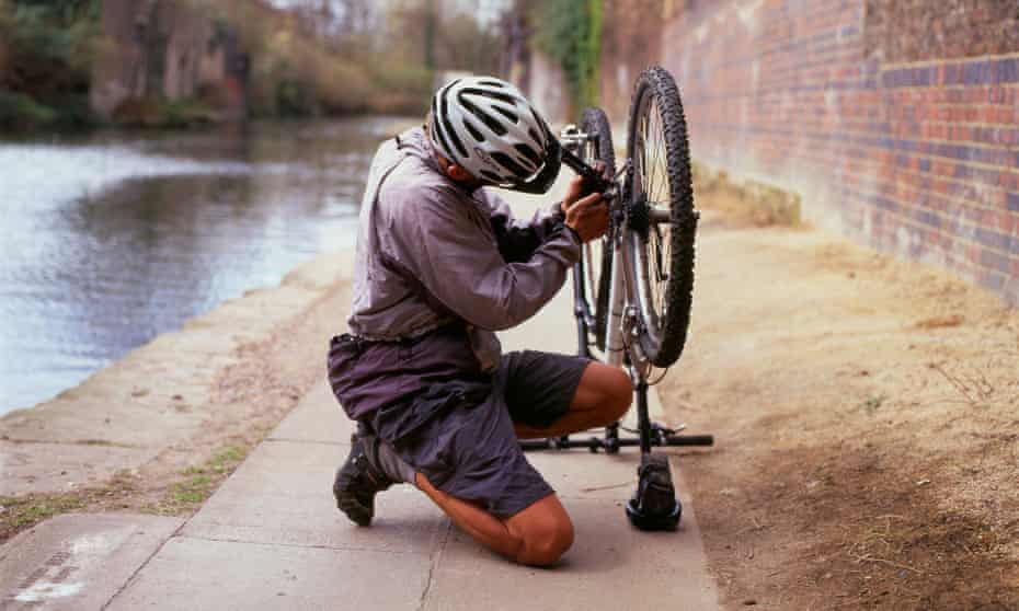 A cyclist fixing a puncture. 