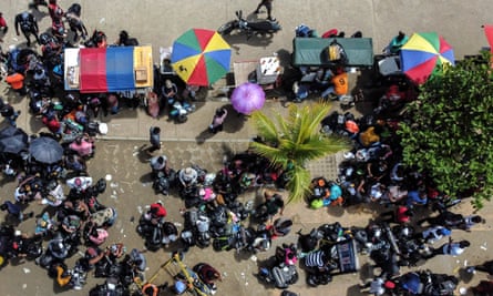 An aerial view of stranded migrants from Cuba, Haiti, Venezuela and several African countries at the entrance of a port as they board a boat to leave Necoclí.