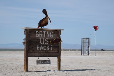 sign says 'bring us back' with a statue of a pelican on top