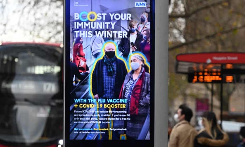 NHS poster in London this December encouraging uptake of Covid-19 booster and flu vaccines