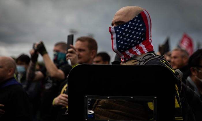 Mad Max. A man hold his hand to his heart as a Proud Boys organizer recites the US pledge of allegiance during a Proud Boys rally in Portland, Oregon on September 26, 2020, as some of the far-right group’s members gather to show support to then-US president Donald Trump.