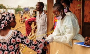 Health workers carry out Ebola checks on the border of Sierra Leone and Liberia.