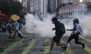 Pro-democracy protesters react as police fire teargas