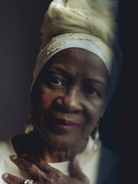 a portrait of a woman with her hand on her chest