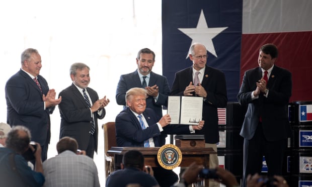 Donald Trump signs a permit at the site of Double Eagle Energy’s oil rig in Midland, Texas, last month.
