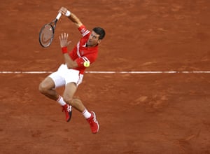 A leaping Novak Djokovic returns to Rafael Nadal.