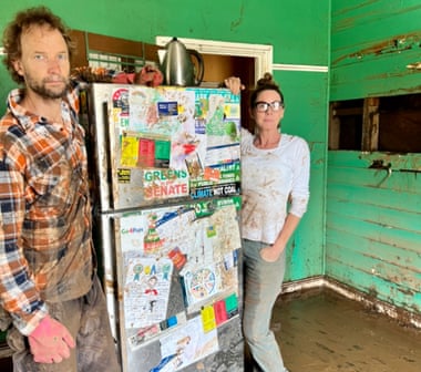 Adam Guise (L ) and Eddie Lloyd (R) with the damaged fridge at Adam’s flooded out home in Lismore.