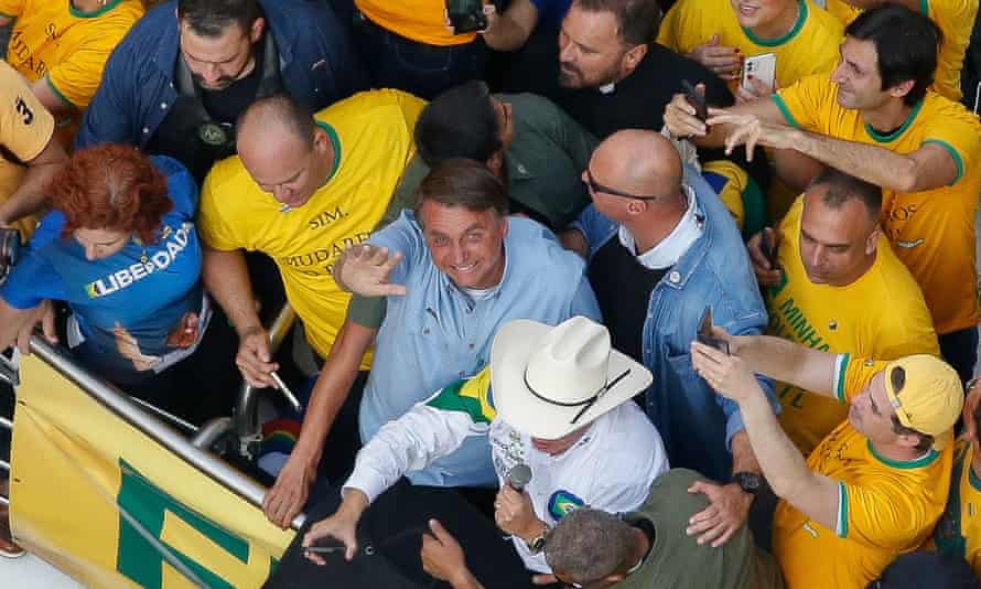 Brazil’s president, Jair Bolsonaro, waves as he joins thousands of supporters in São Paulo in September