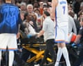 Medical staff wheel injured Thunder guard Jalen Williams off court on a stretcher