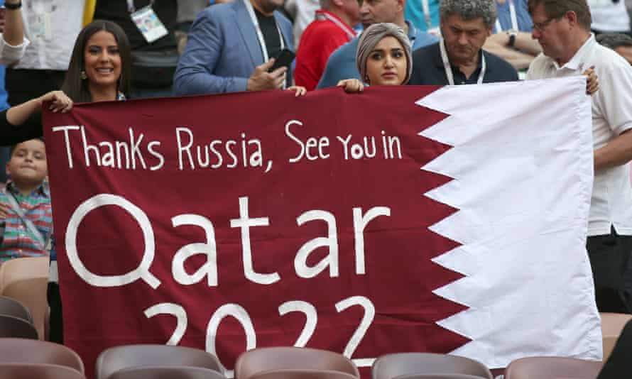 Fans at the 2018 World Cup final with a banner looking forward to 2022