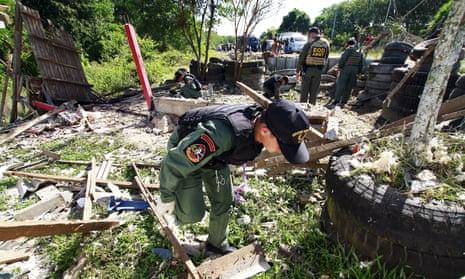 Troops inspect the site of a bomb blast in Khok Pho, Thailand.