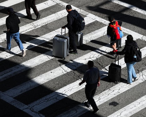 People dragging luggage through airport