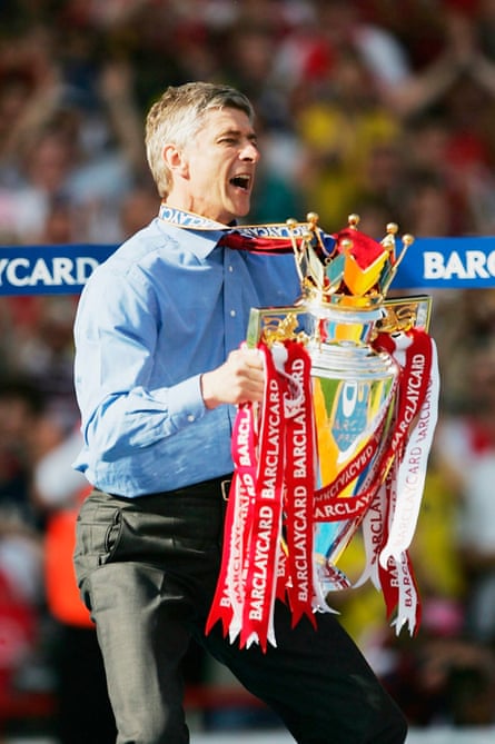 Arsenal manager Arsène Wenger lifts the Premiership trophy at Highbury in 2004.