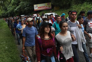 Honduran immigrants, some of more than 1,500 people in a migrant caravan, travel north near Quezaltepeque, Guatemala.