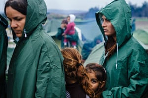 Migrants queue for food at a makeshift camp near the border between Greece and Macedonia