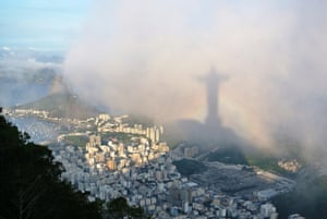 Corcovado, Rio de Janeiro. As light flooded across the city, I noticed the shadow of Christ the Redeemer fill my frame and quickly took a series of shots, as a rainbow briefly gave the statue its own halo.