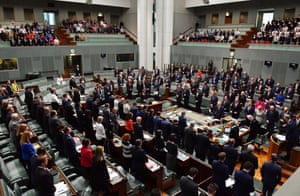 Australian MPs stand in condolence for the victims of the Manchester terrorist bombing during Question Time in the House of Representatives at Parliament House in Canberra